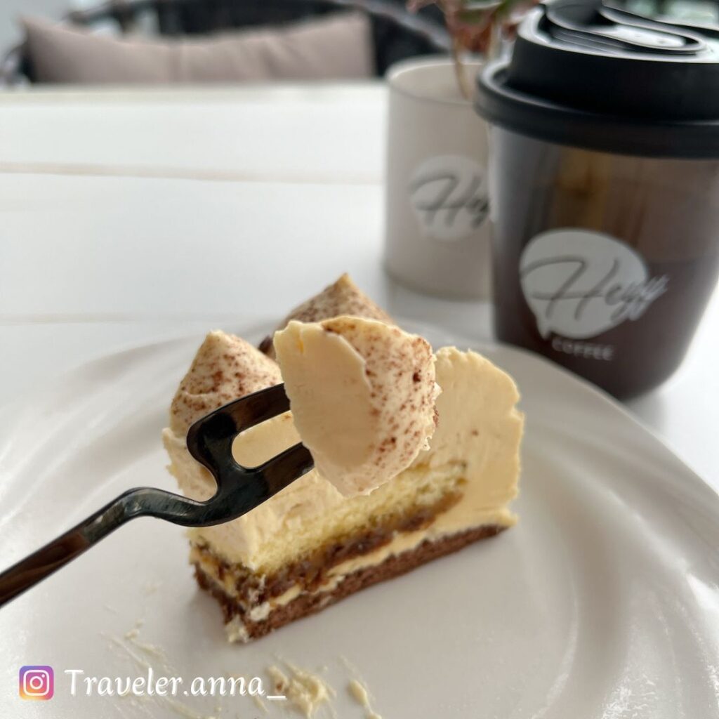 a piece of cake with a fork on a white plate,heyy-coffee-traveleranna