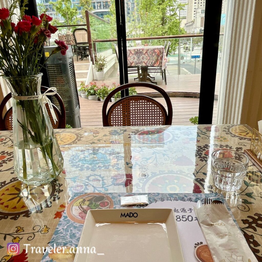 a table with a vase of flowers and a glass vase on it