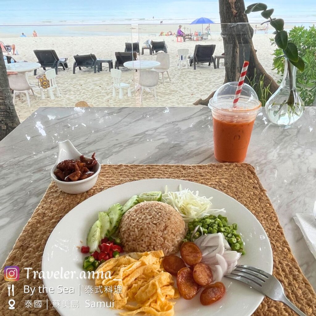 a plate of food on a table with a beach in the background